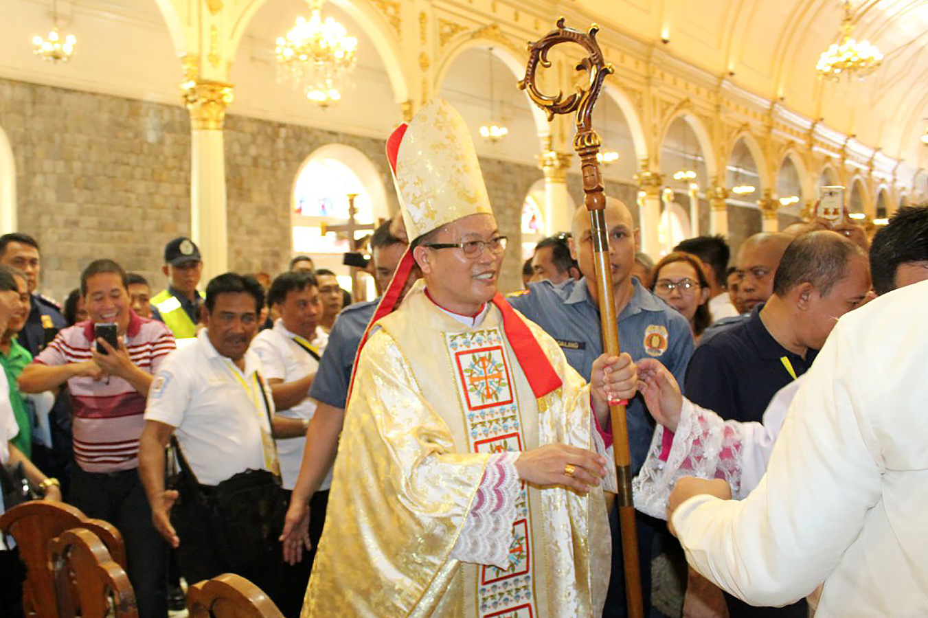 Bishop Louie Galbines of Kabankalan is greeted by crowd after his episcopal ordination at the San Sebastian Cathedral in Bacolod City on May 28. PHOTO FROM BACOLOD PNP FACEBOOK PAGE
