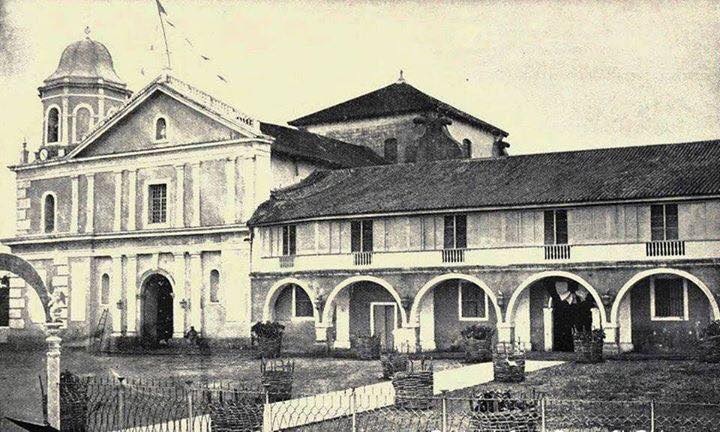 The church and its patio with the solid iron fence surrounding it.