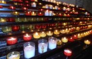 Why do Catholics light votive candles?
